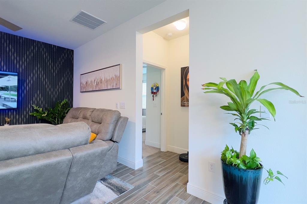 2755 Mdw Strm Way Clermont, FL 34714 - Photo 29 of 64 a living room with furniture and a potted plant