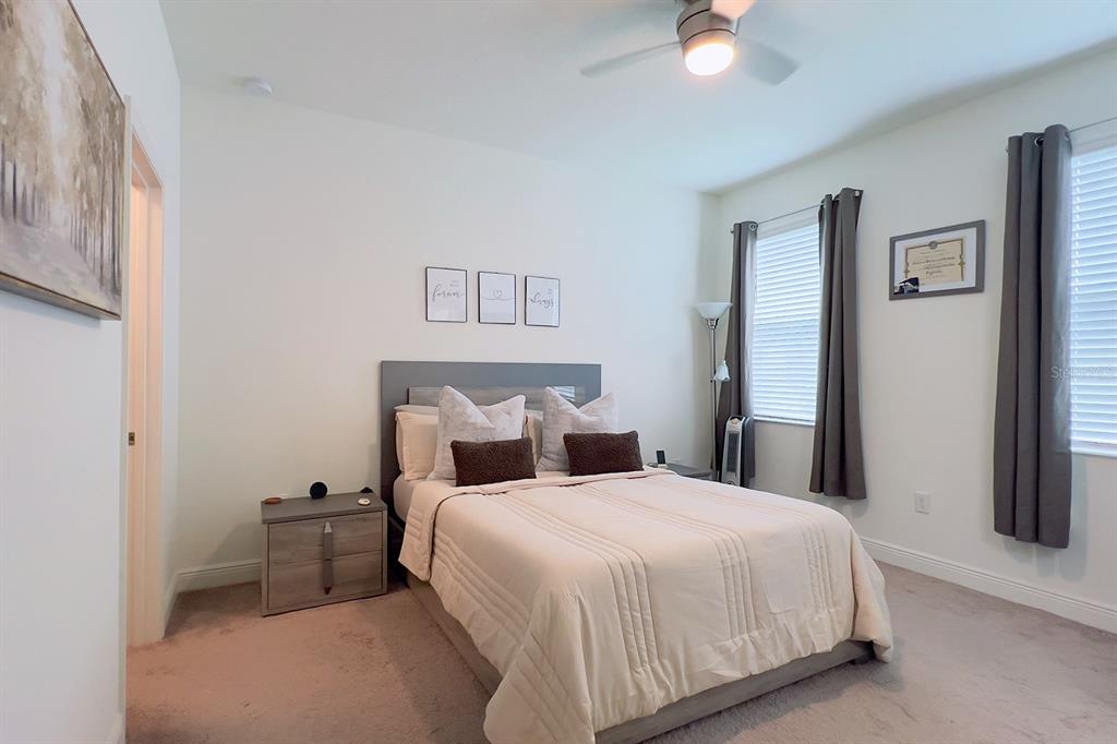 2755 Mdw Strm Way Clermont, FL 34714 - Photo 31 of 64 a bedroom with a bed and a chandelier