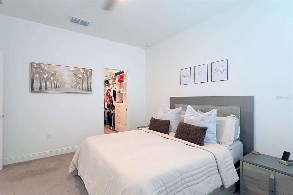 2755 Mdw Strm Way Clermont, FL 34714 - Photo 32 of 64 a bedroom with a bed and a wall painting