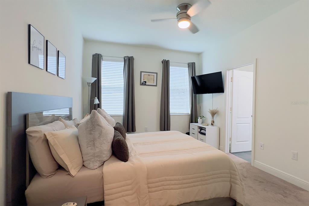 2755 Mdw Strm Way Clermont, FL 34714 - Photo 33 of 64 a bedroom with a bed and a flat screen tv