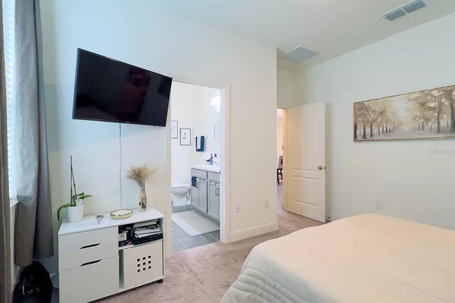 a bathroom with a sink a toilet a mirror and shower curtain