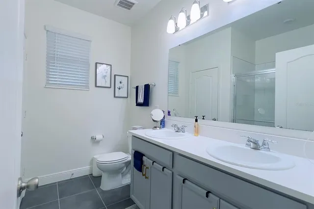 a bedroom with a bed and painting on the wall