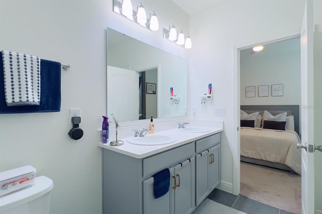 2755 Mdw Strm Way Clermont, FL 34714 - Photo 39 of 64 a bathroom with a double vanity sink mirror and toilet