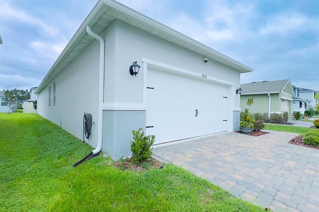 2755 Mdw Strm Way Clermont, FL 34714 - Photo 4 of 64 a front view of a house with a yard and garage