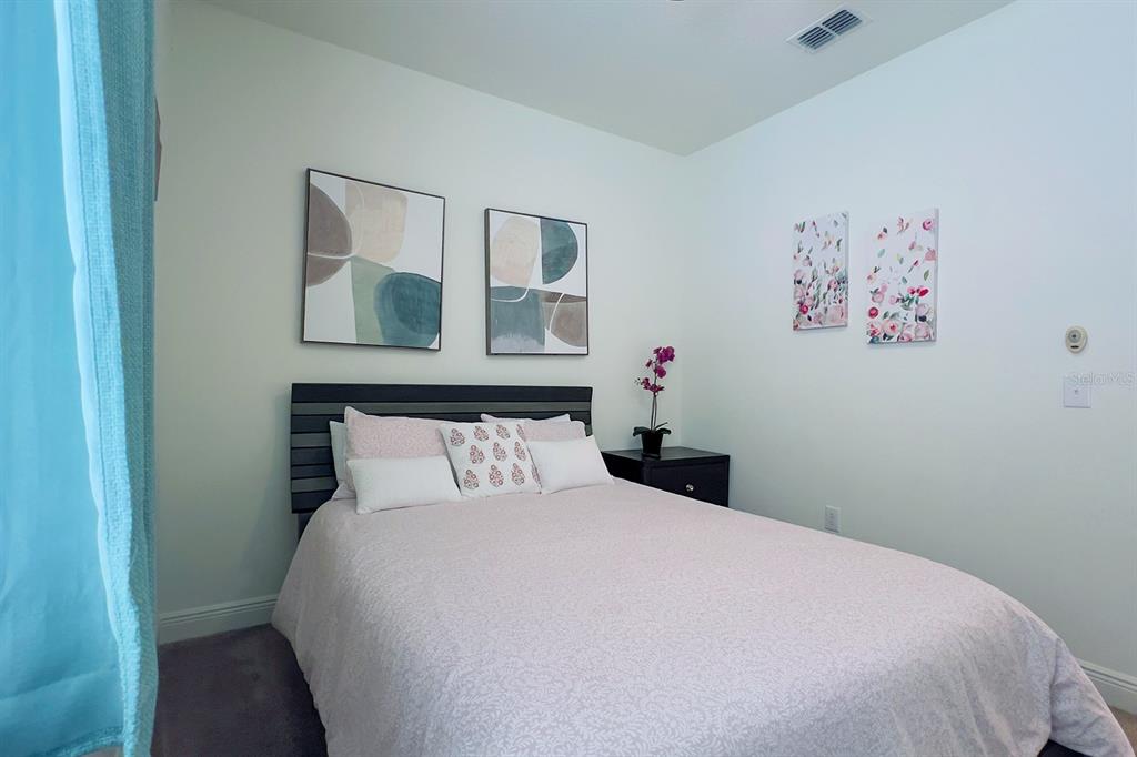 2755 Mdw Strm Way Clermont, FL 34714 - Photo 44 of 64 a bedroom with a bed and painting on the wall