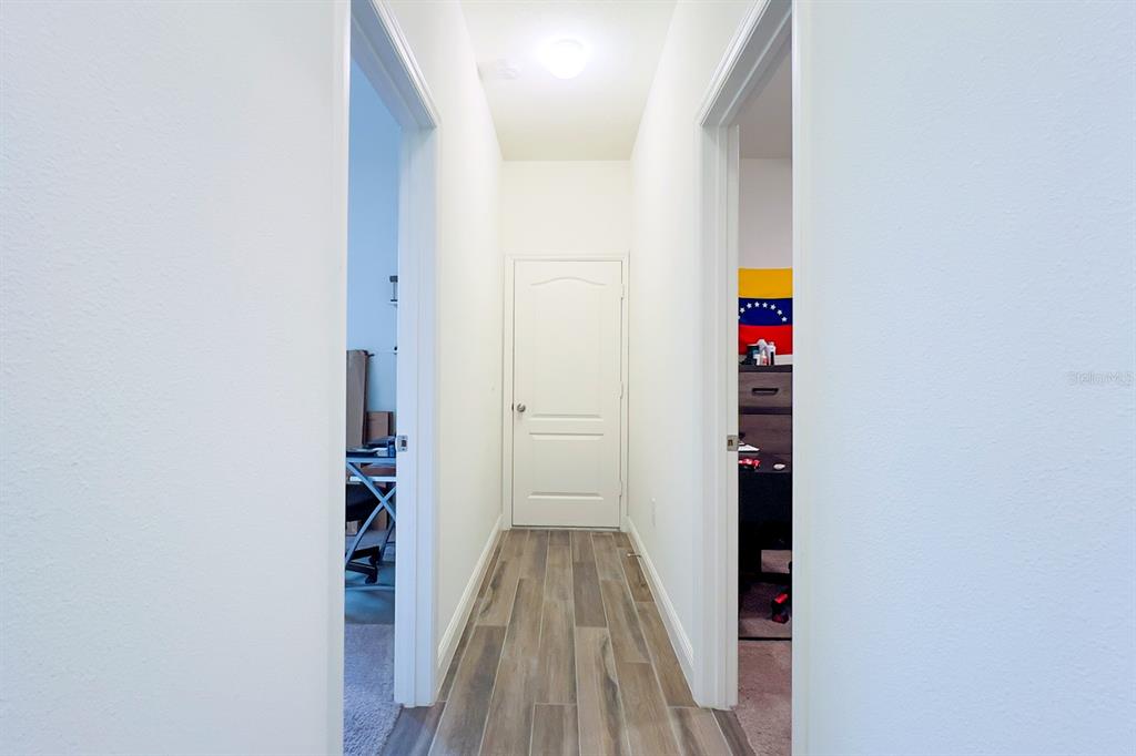 2755 Mdw Strm Way Clermont, FL 34714 - Photo 49 of 64 a view of hallway with wooden floor and closet