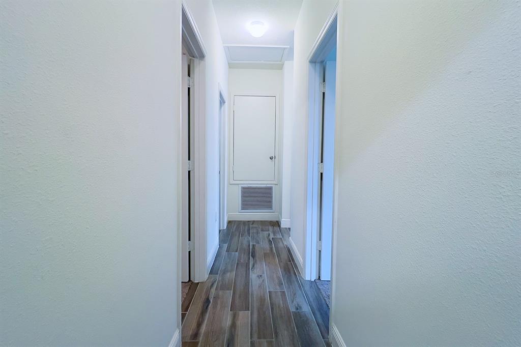 2755 Mdw Strm Way Clermont, FL 34714 - Photo 55 of 64 a view of a hallway with wooden floor