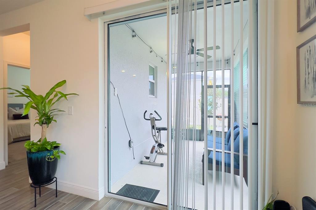 2755 Mdw Strm Way Clermont, FL 34714 - Photo 57 of 64 a glass door with a potted plant