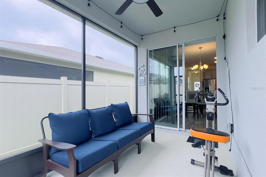 2755 Mdw Strm Way Clermont, FL 34714 - Photo 60 of 64 a living room with furniture and a chandelier