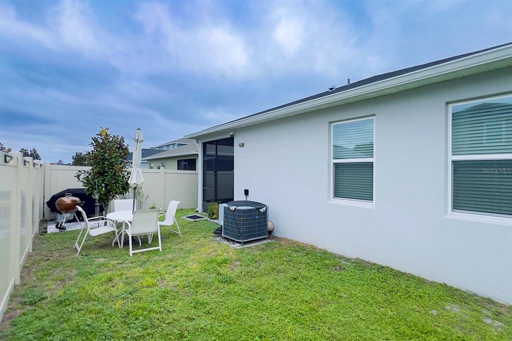 2755 Mdw Strm Way Clermont, FL 34714 - Photo 64 of 64 a backyard of a house with table and chairs