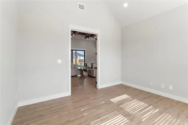 a bathroom with a granite countertop sink a toilet a mirror a vanity and shower