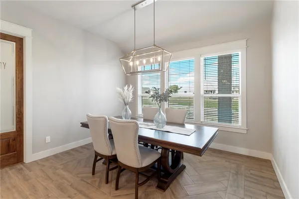 a view of a room with a ceiling fan and wooden floor