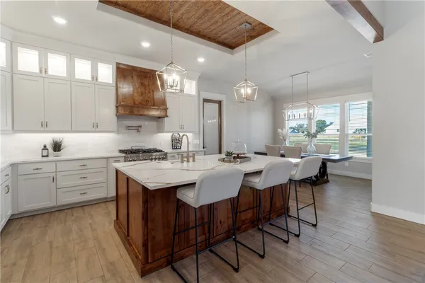 a view of a dining room with furniture wooden floor and chandelier