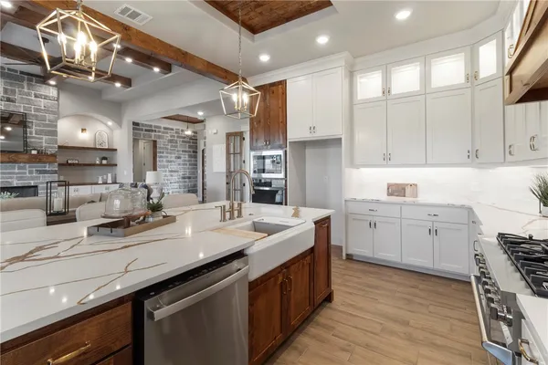 an empty room with wooden floor ceiling fan and windows