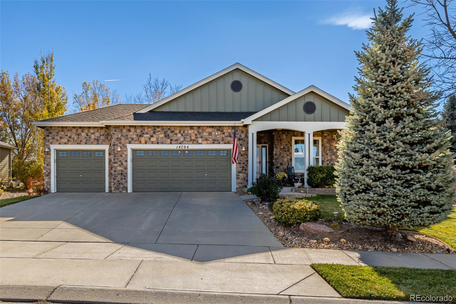 14704 Eagle River Loop Broomfield, CO 80023 - Photo 1 of 30 a front view of a house with garden