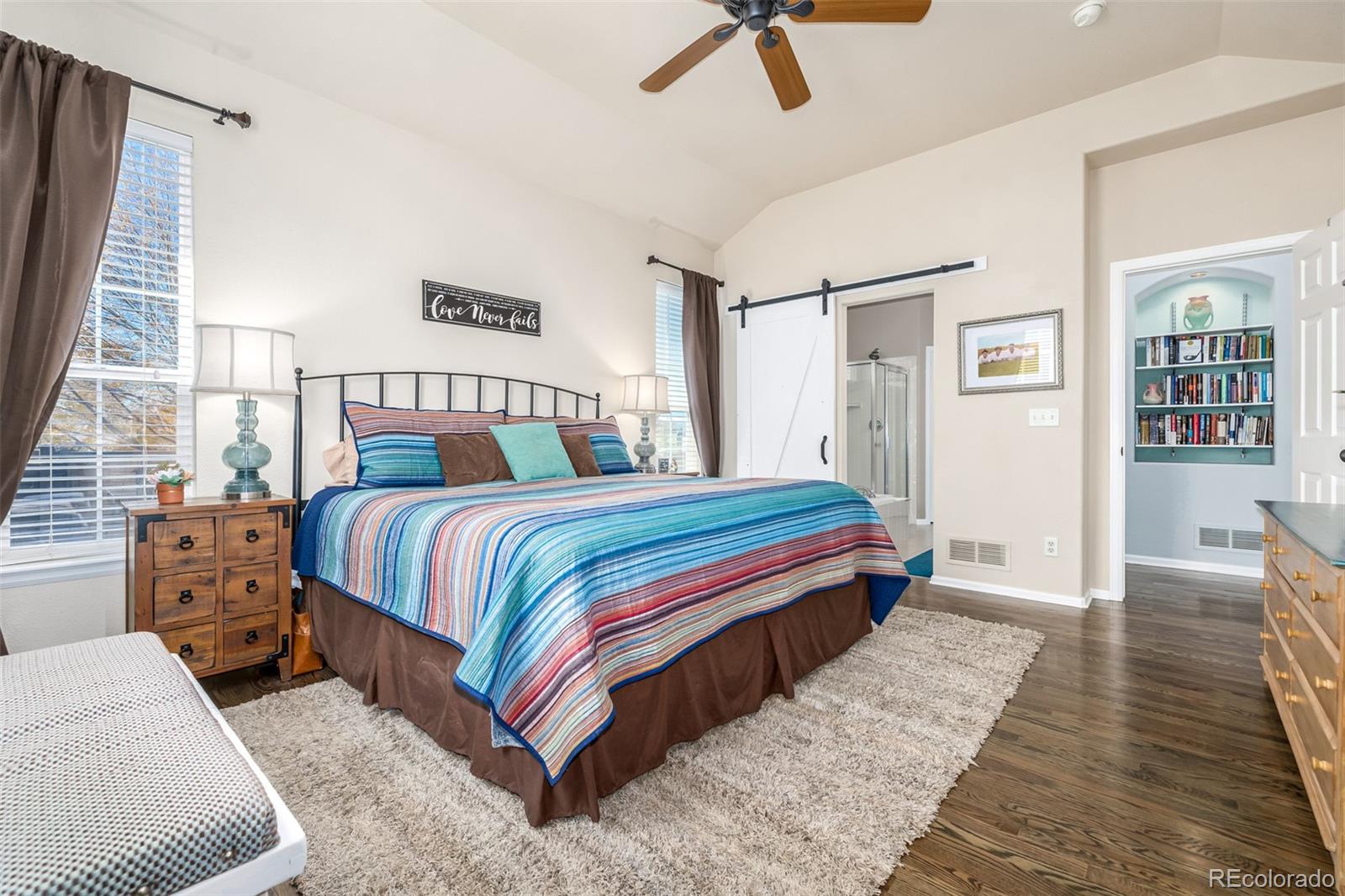 14704 Eagle River Loop Broomfield, CO 80023 - Photo 14 of 30 a bedroom with a bed and wooden floor