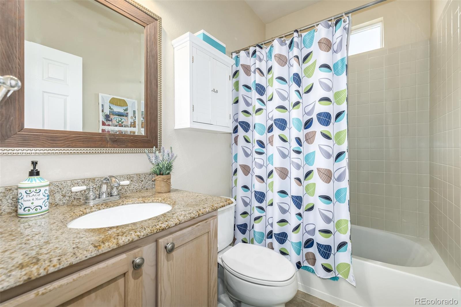 14704 Eagle River Loop Broomfield, CO 80023 - Photo 19 of 30 a bathroom with a granite countertop sink a toilet and a mirror