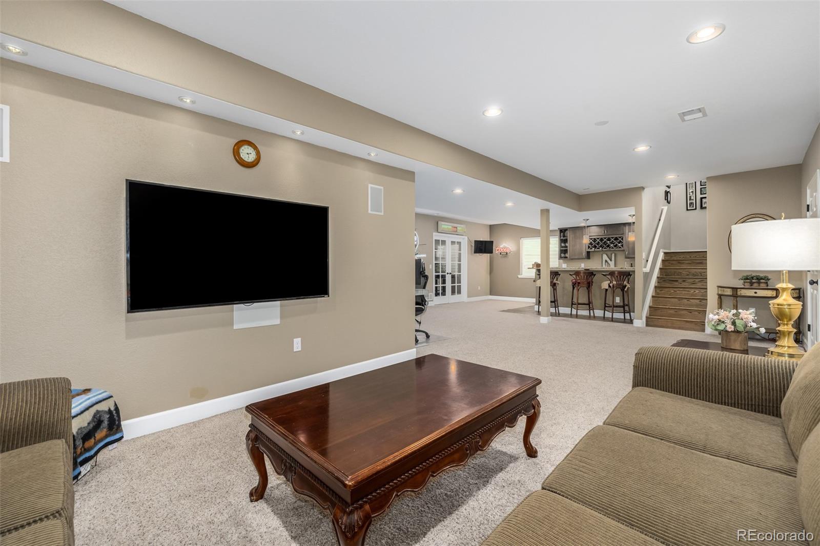 14704 Eagle River Loop Broomfield, CO 80023 - Photo 20 of 30 a living room with furniture and a flat screen tv