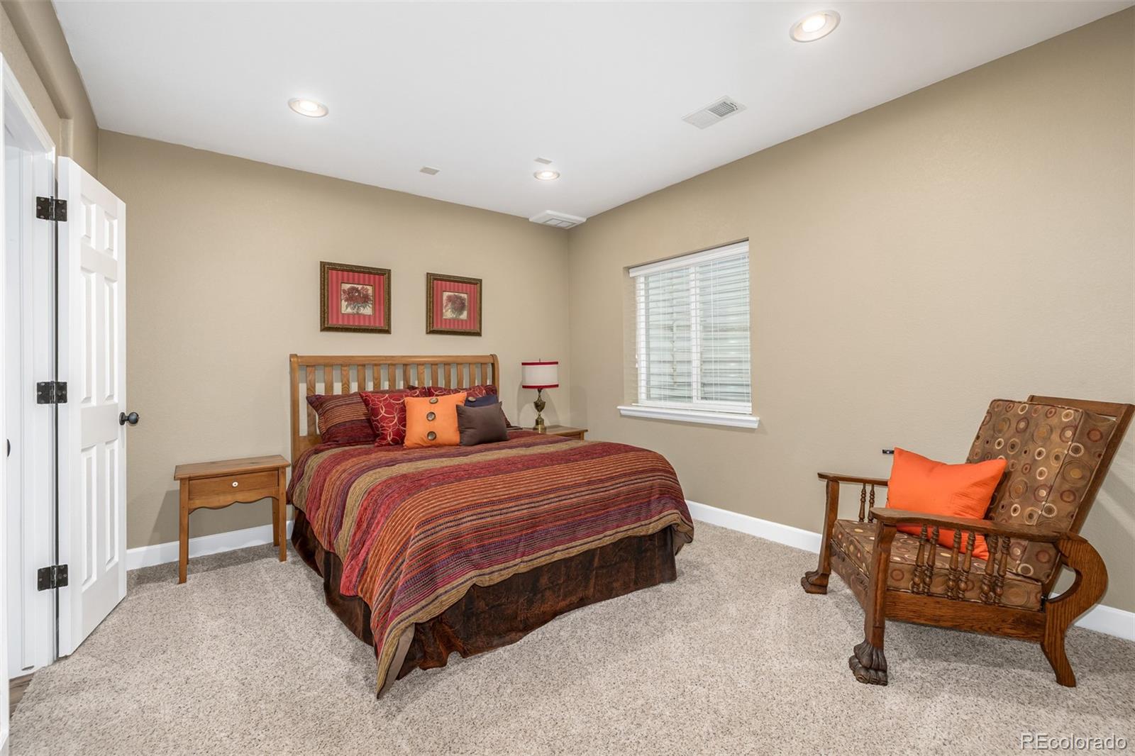 14704 Eagle River Loop Broomfield, CO 80023 - Photo 24 of 30 a bedroom with a bed and chair