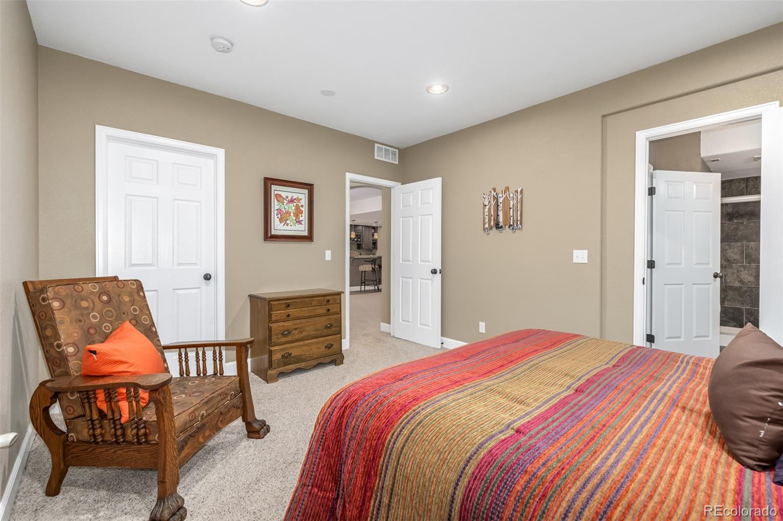 14704 Eagle River Loop Broomfield, CO 80023 - Photo 25 of 30 a bedroom with a bed and chair