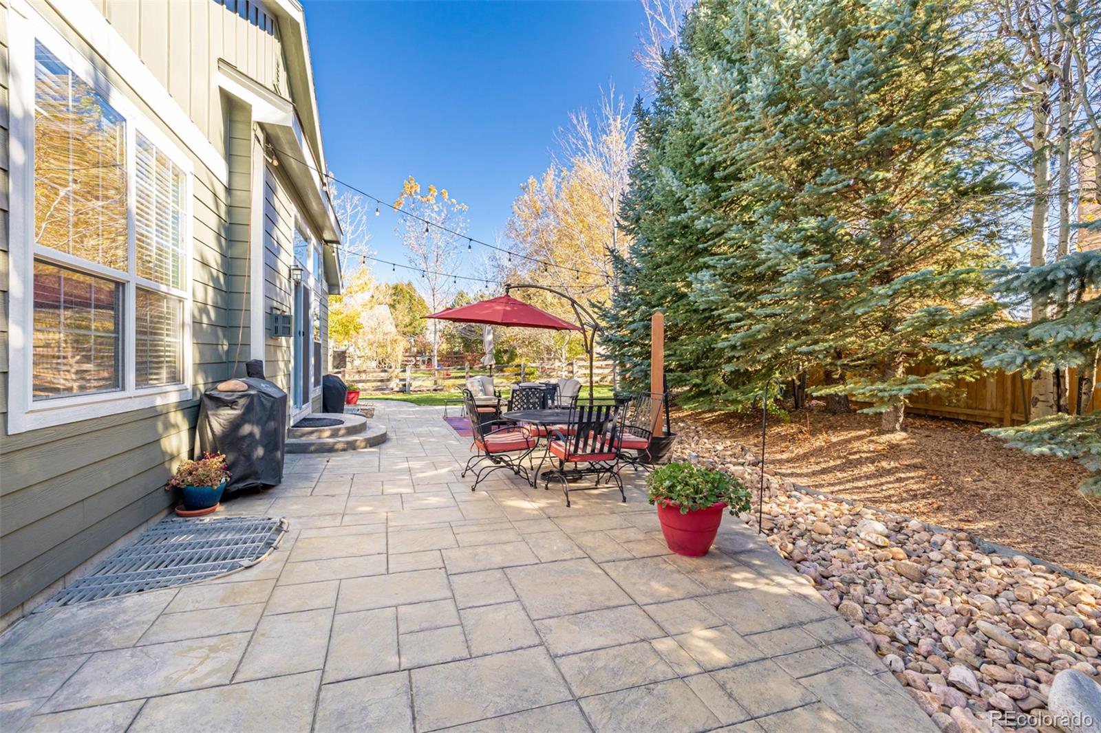14704 Eagle River Loop Broomfield, CO 80023 - Photo 29 of 30 a view of a chairs and tables in the patio with a backyard