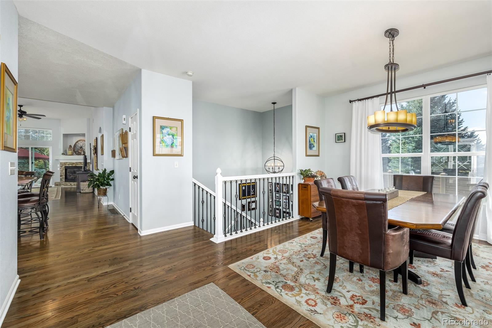 14704 Eagle River Loop Broomfield, CO 80023 - Photo 7 of 30 a dining room with furniture a chandelier and wooden floor