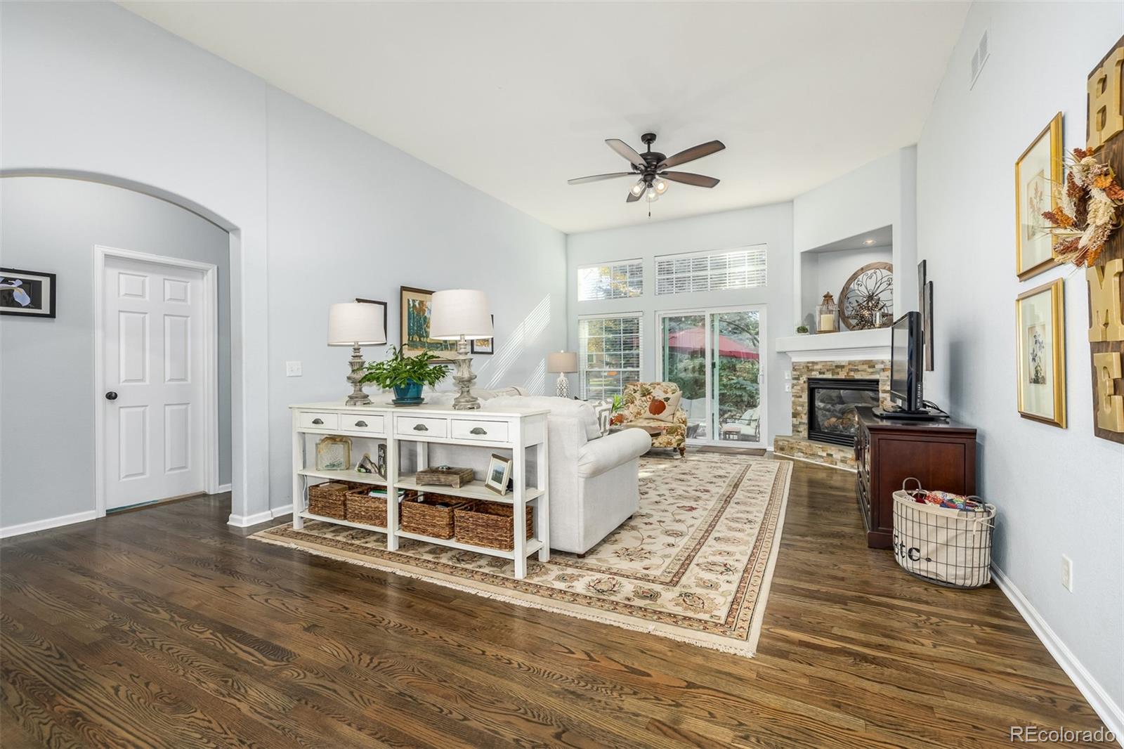 14704 Eagle River Loop Broomfield, CO 80023 - Photo 8 of 30 a living room with furniture a fireplace and a table