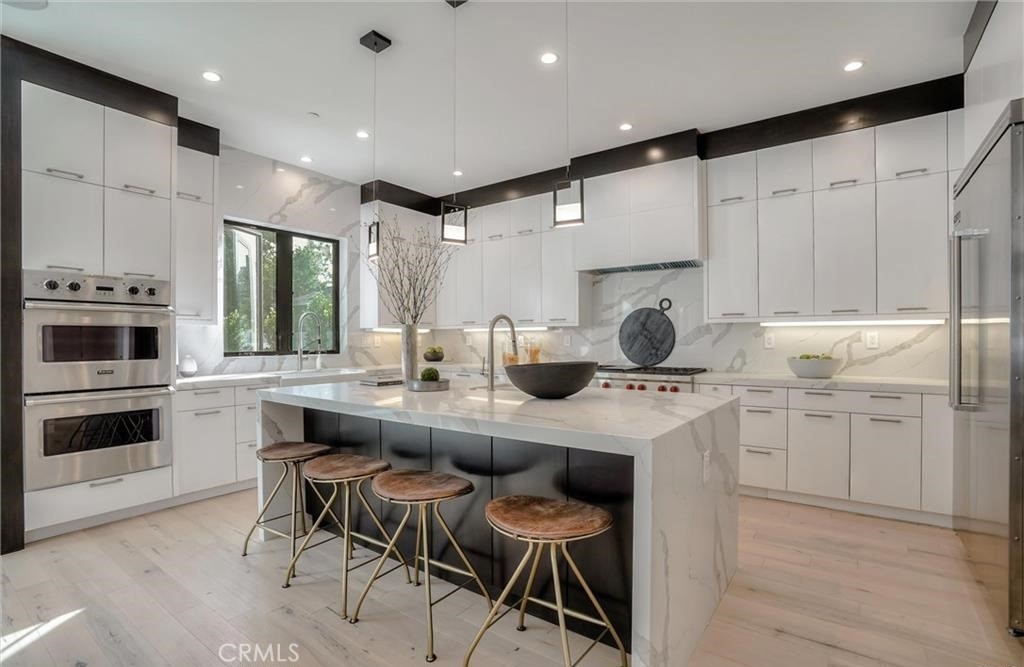 15926 Morrison Street Encino, CA 91436 - Photo 15 of 67 a kitchen with counter top space cabinets and stainless steel appliances