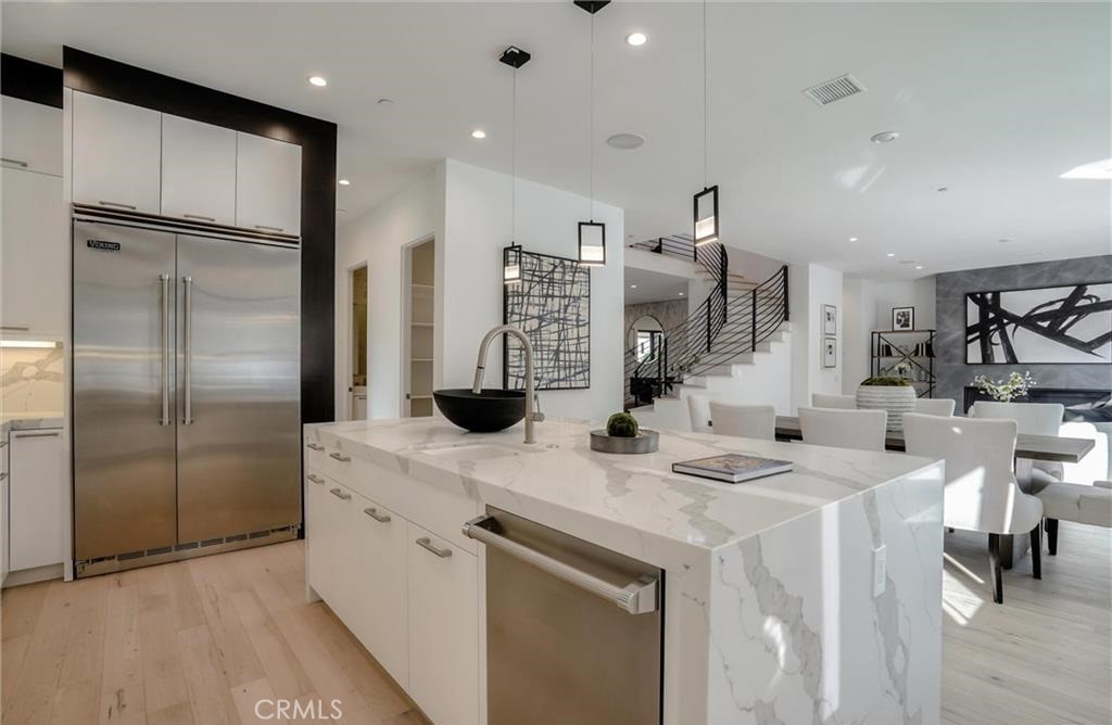 15926 Morrison Street Encino, CA 91436 - Photo 18 of 67 a kitchen that has a lot of cabinets a sink and appliances in it