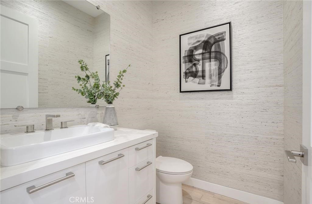 15926 Morrison Street Encino, CA 91436 - Photo 19 of 67 a bathroom with a toilet sink and mirror