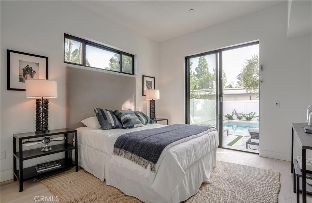 15926 Morrison Street Encino, CA 91436 - Photo 25 of 67 a bedroom with a bed a mirror and a large window