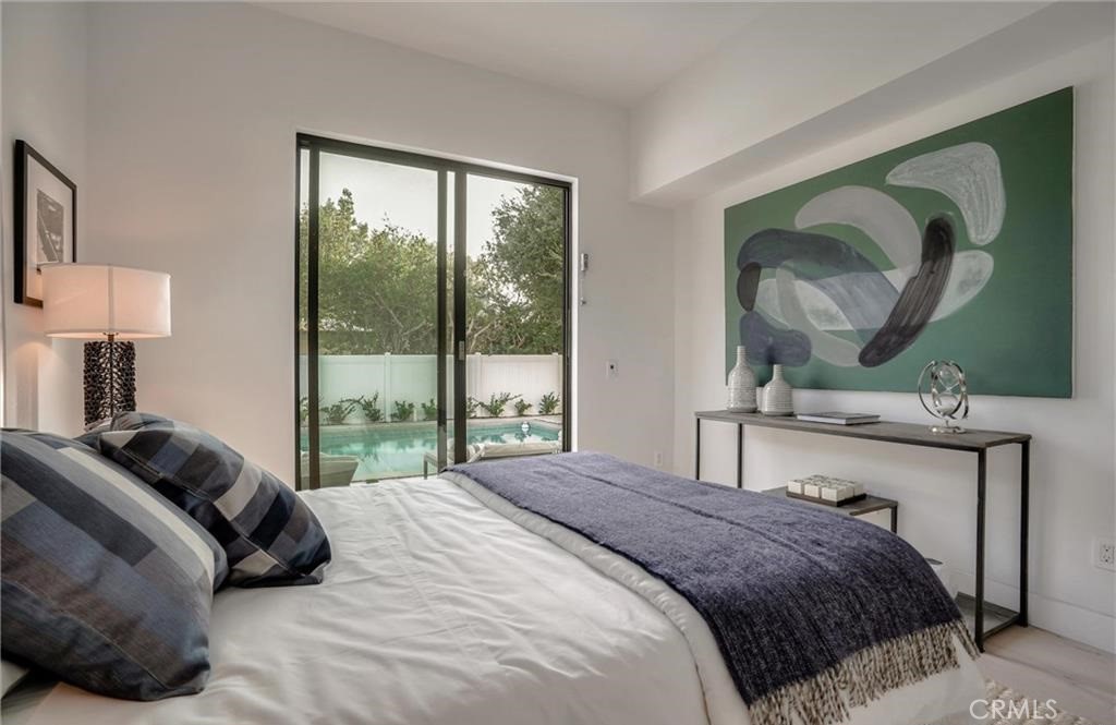 15926 Morrison Street Encino, CA 91436 - Photo 26 of 67 a bedroom with a bed lamp and a large window with outer view