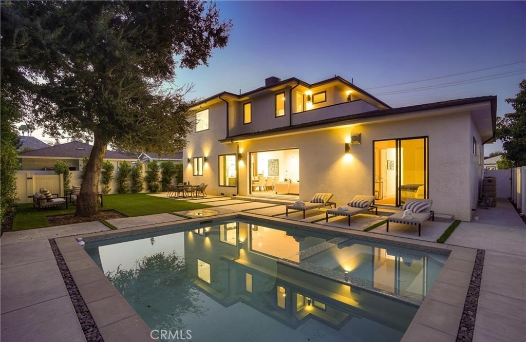 15926 Morrison Street Encino, CA 91436 - Photo 3 of 67 a front view of a house with swimming pool and outdoor seating