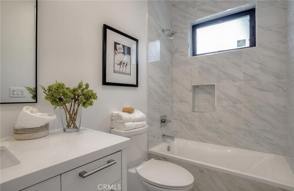 15926 Morrison Street Encino, CA 91436 - Photo 34 of 67 a bathroom with a sink a toilet and bathtub