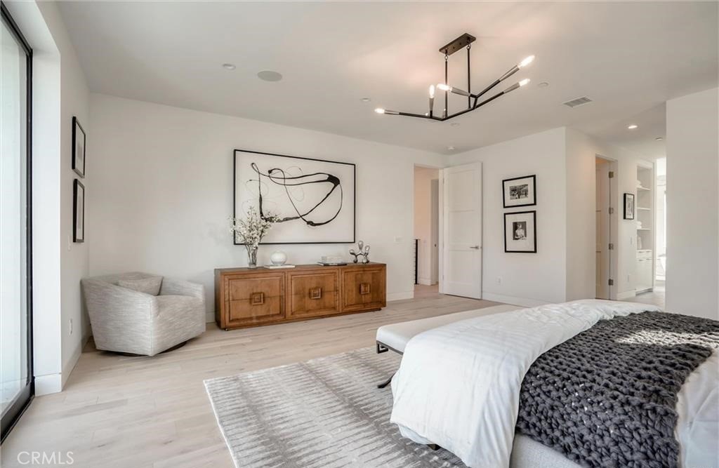15926 Morrison Street Encino, CA 91436 - Photo 37 of 67 a bedroom with a large bed couch and painting on the wall