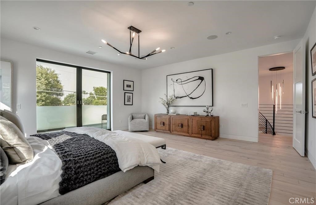 15926 Morrison Street Encino, CA 91436 - Photo 38 of 67 a bedroom with a large bed and a chandelier