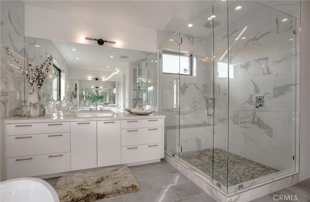 15926 Morrison Street Encino, CA 91436 - Photo 43 of 67 a bathroom with a shower sink and mirror