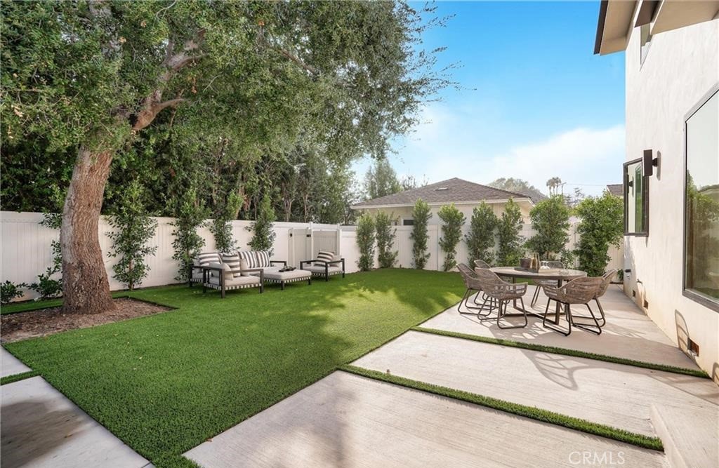 15926 Morrison Street Encino, CA 91436 - Photo 51 of 67 a view of a patio with table and chairs potted plants and large tree