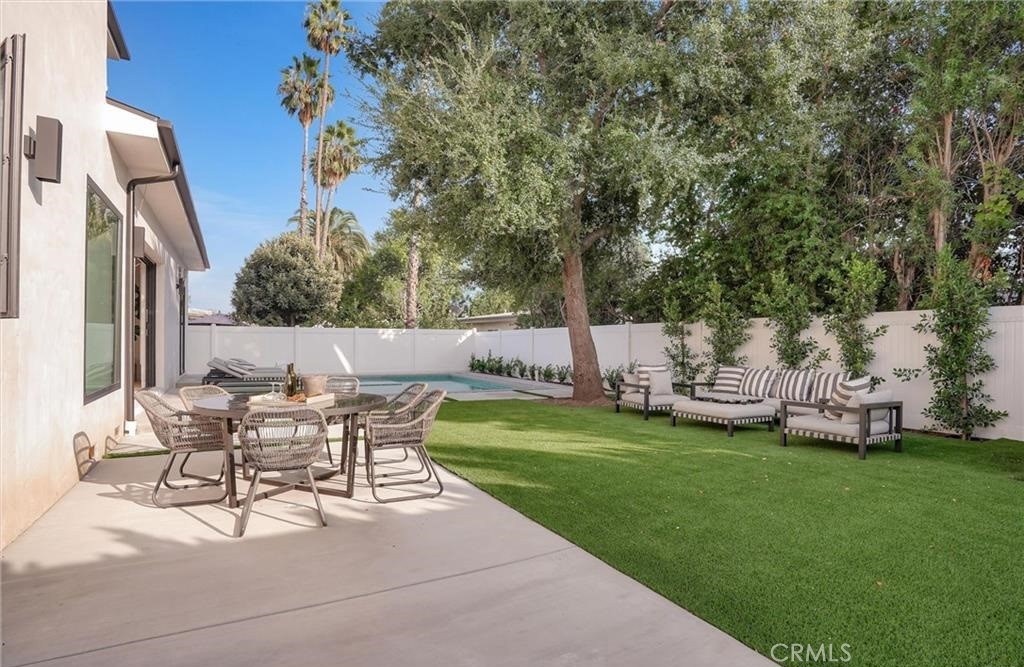 15926 Morrison Street Encino, CA 91436 - Photo 53 of 67 a view of a patio with table and chairs and potted plants