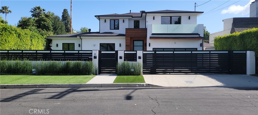 15926 Morrison Street Encino, CA 91436 - Photo 64 of 67 a front view of a house with a yard and garage