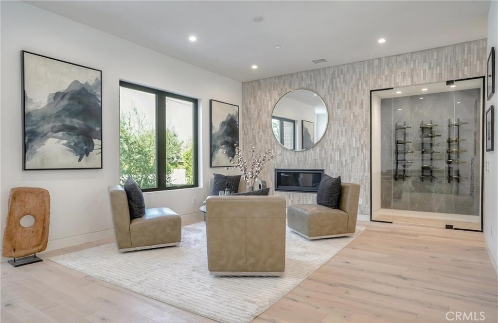 15926 Morrison Street Encino, CA 91436 - Photo 8 of 67 a living room with furniture a large window and a fireplace