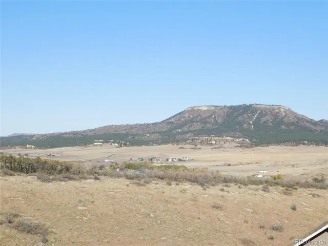 a view of an ocean beach and mountain