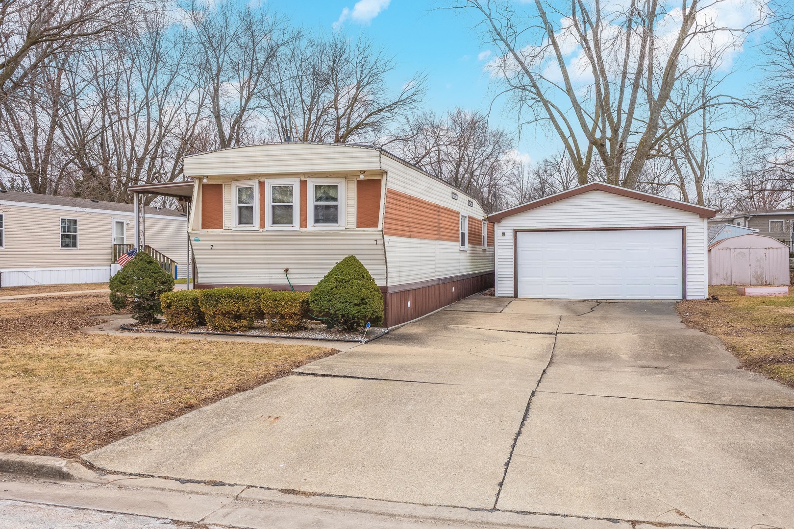 7 Oak Valley Road Bloomington, IL 61704 - Photo 1 of 27 a front view of a house with a garden and trees