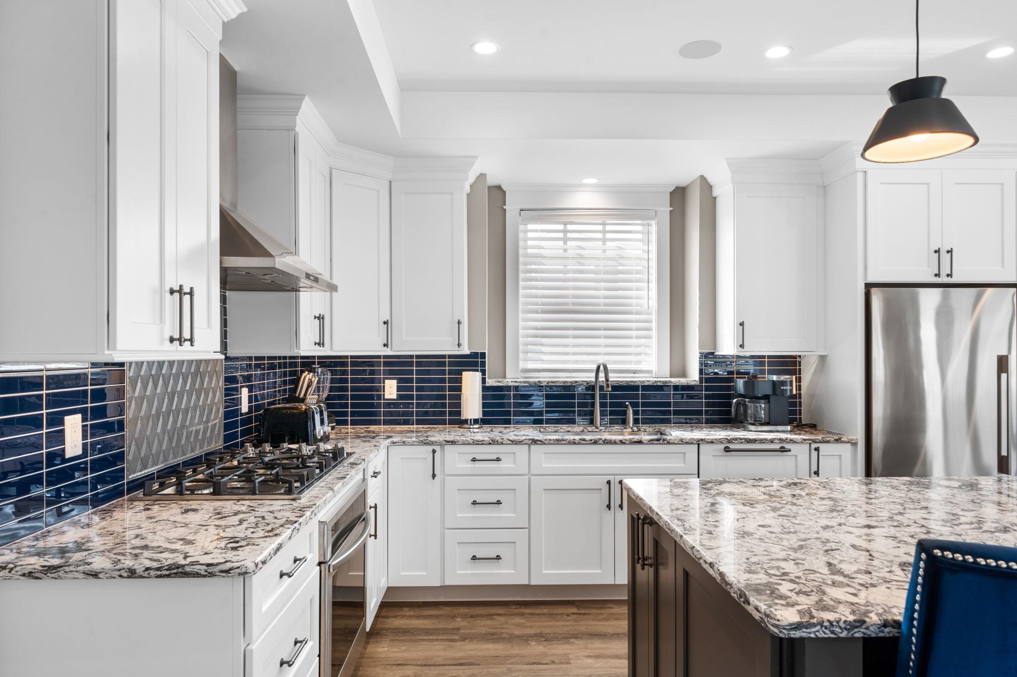 75 24th Street East Avalon, NJ 08202 - Photo 14 of 47 a kitchen with granite countertop a sink stove and refrigerator