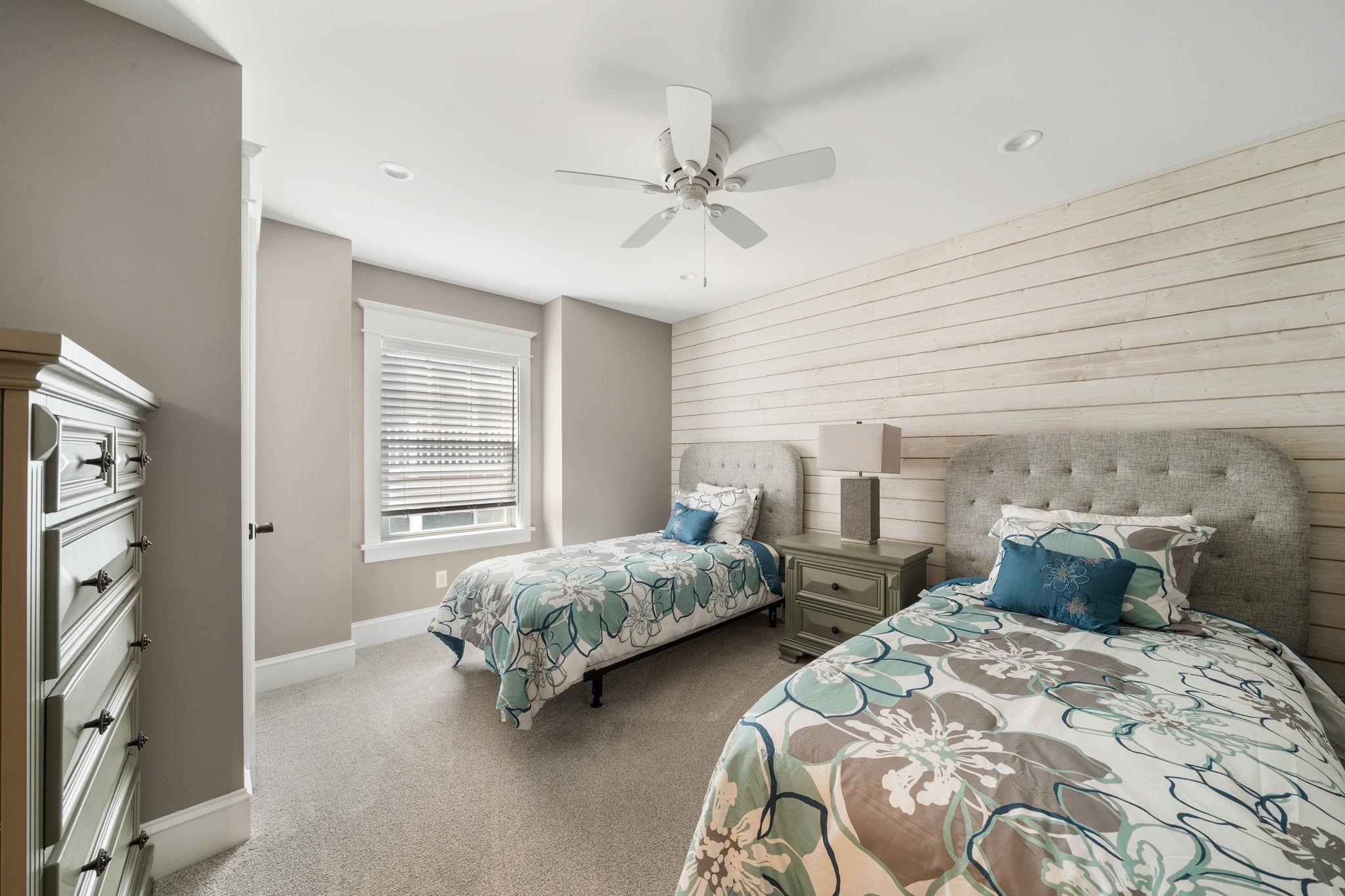 75 24th Street East Avalon, NJ 08202 - Photo 26 of 47 a bedroom with two beds and a chandelier