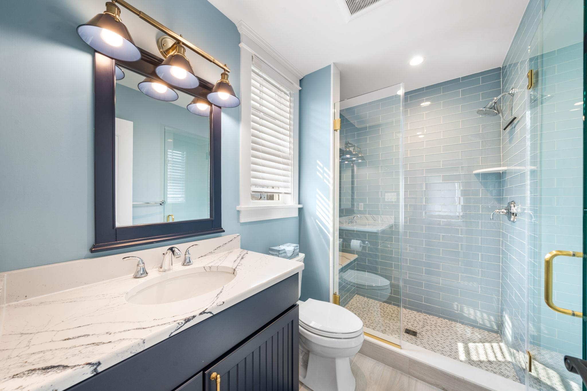 75 24th Street East Avalon, NJ 08202 - Photo 33 of 47 a bathroom with a granite countertop sink toilet mirror and shower