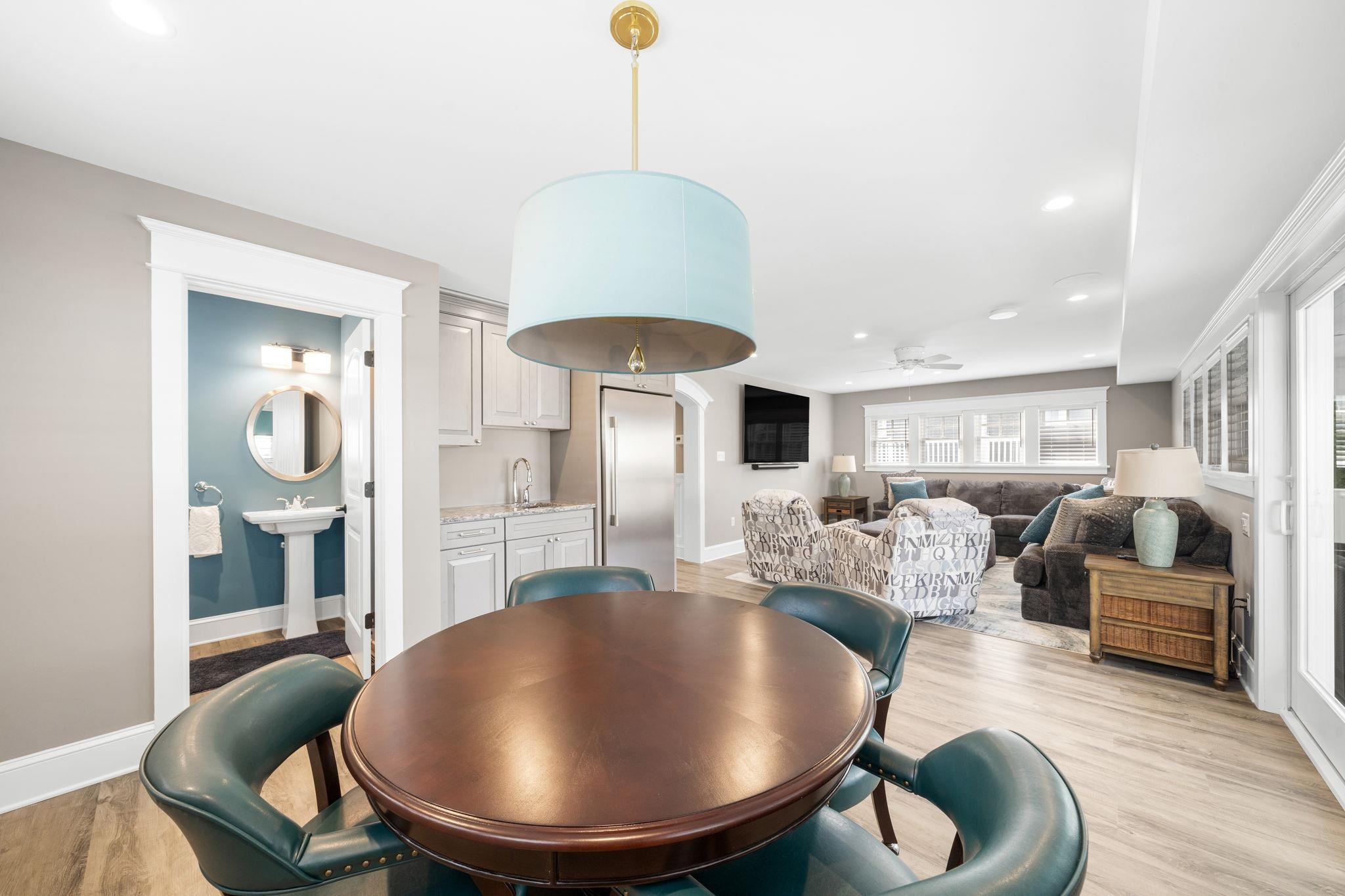 75 24th Street East Avalon, NJ 08202 - Photo 9 of 47 a living room with furniture a mirror and a chandelier