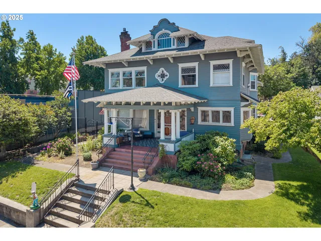 a patio with table and chairs and potted plants
