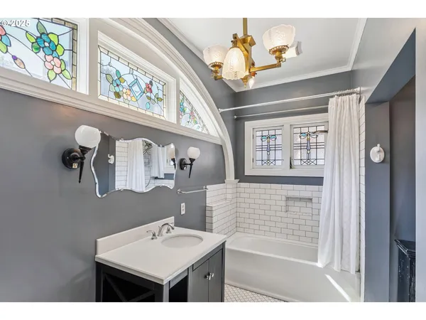 a bathroom with a sink a toilet and a window