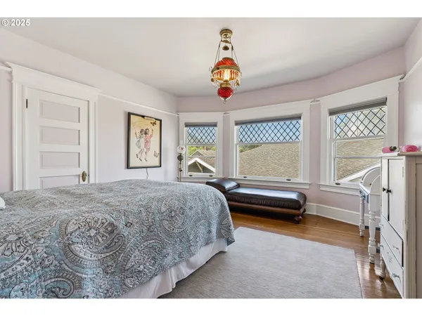 a bedroom with a bed and a large window